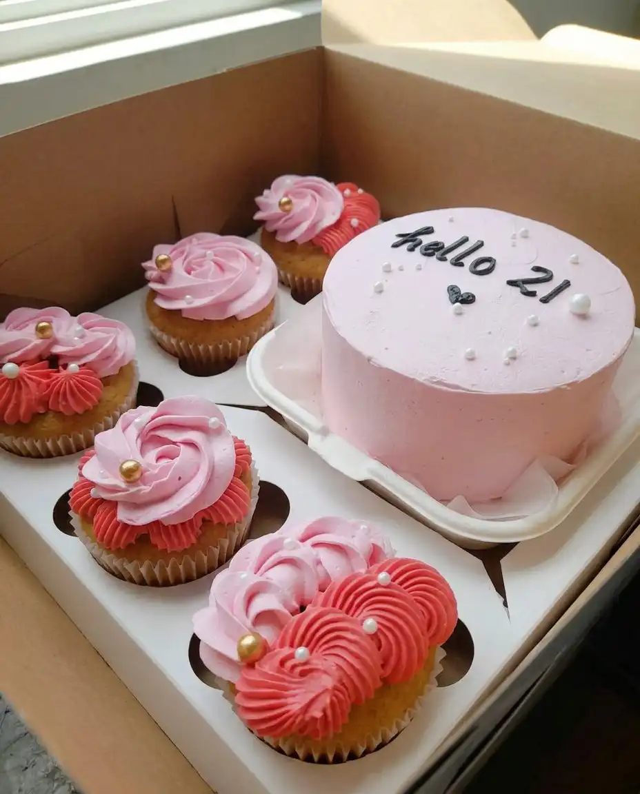 Hand using a small spatula to smooth white frosting on a tiny cake