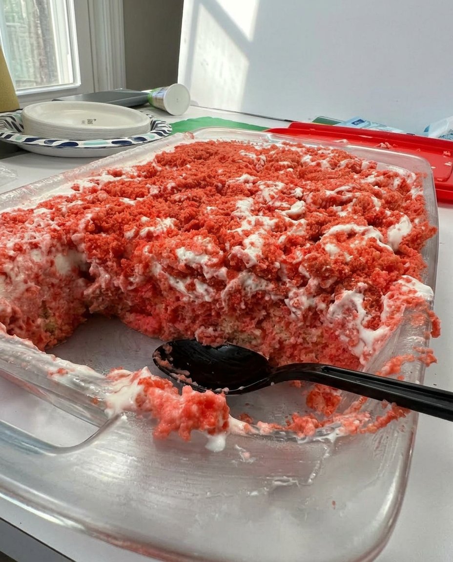 A full 9x13 pan of strawberry crunch cake topped with fresh strawberries