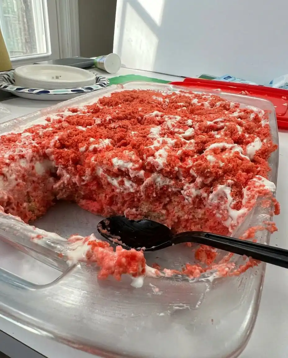 A full 9x13 pan of strawberry crunch cake topped with fresh strawberries