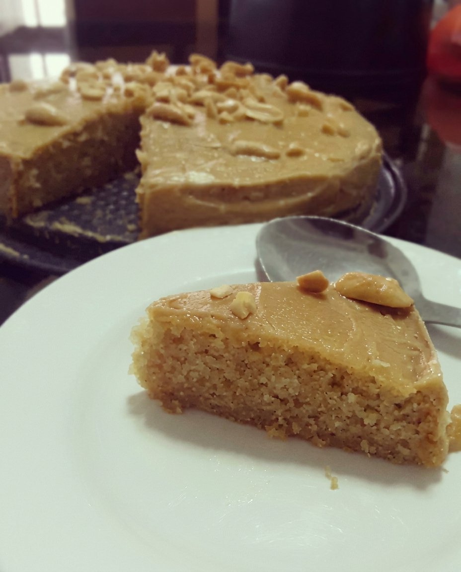 A box of cake mix surrounded by fresh eggs and a bowl of sour cream on a marble counter.
