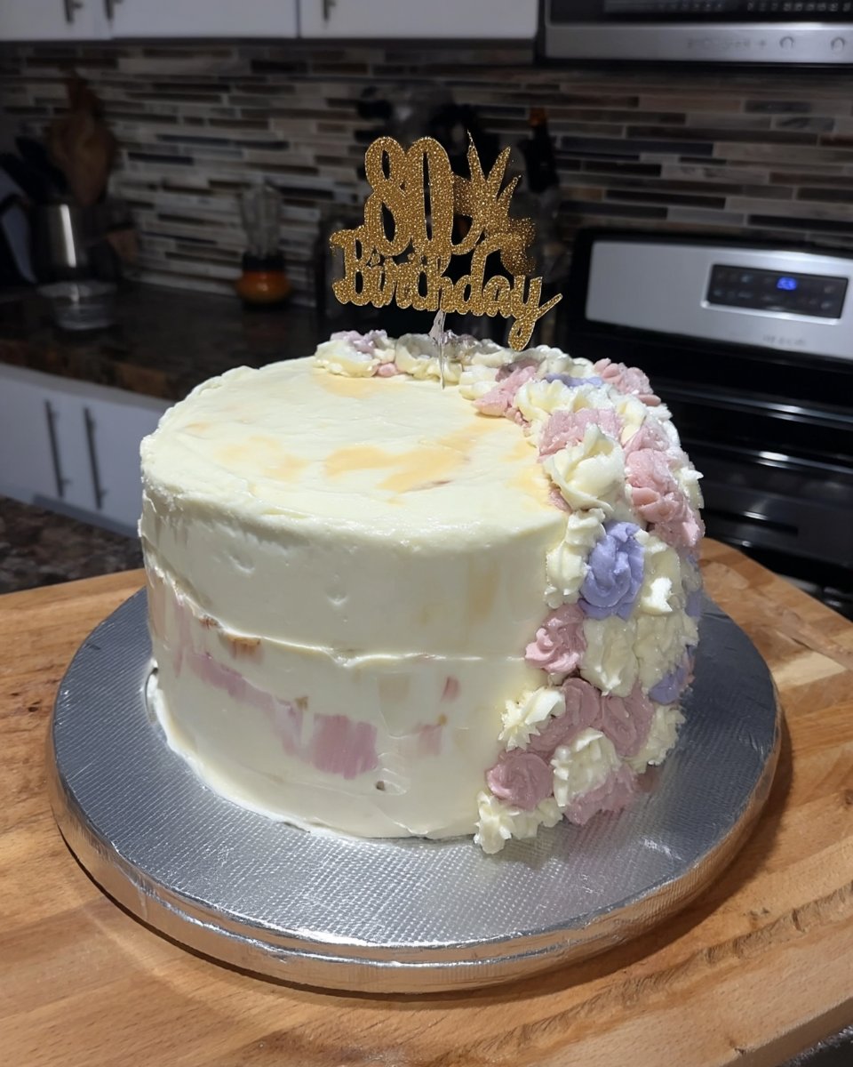 A vintage floral cake with pink sponge and multicolored buttercream flowers