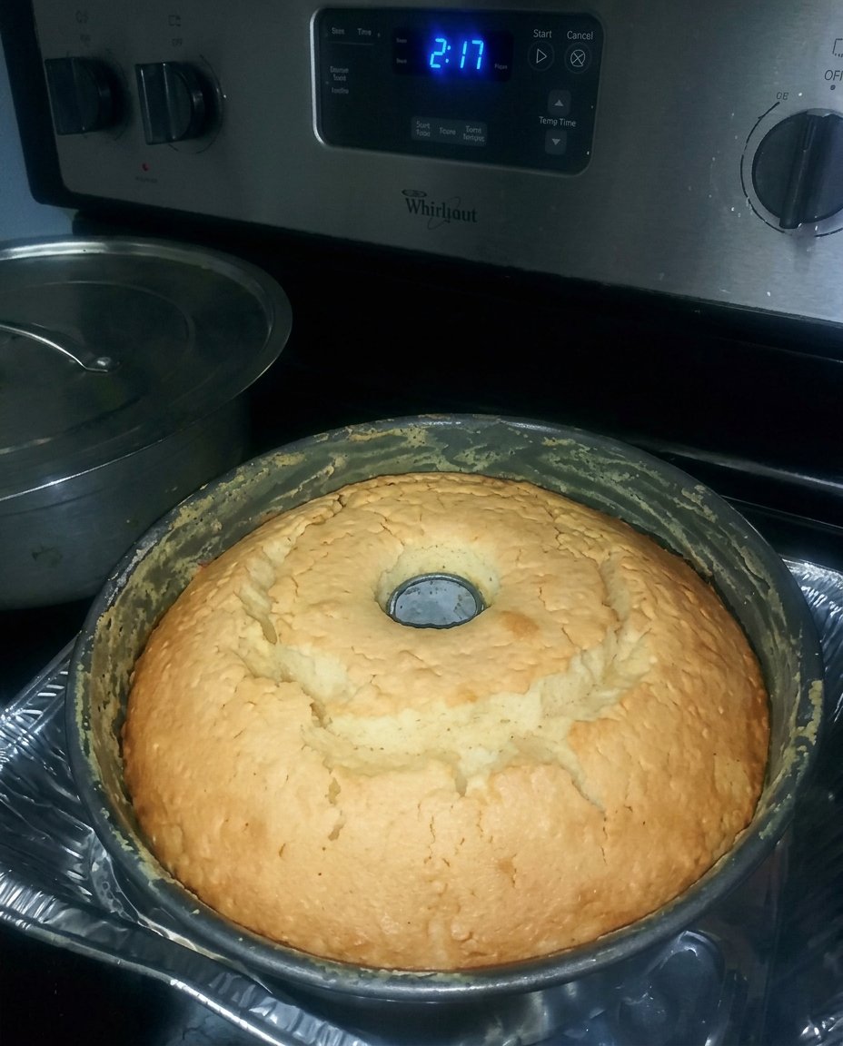 A golden 7 Up cake in a Bundt shape with a light lemon glaze dripping down the sides.