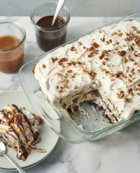 A round ice cream sandwich cake with sugar cones and sprinkles