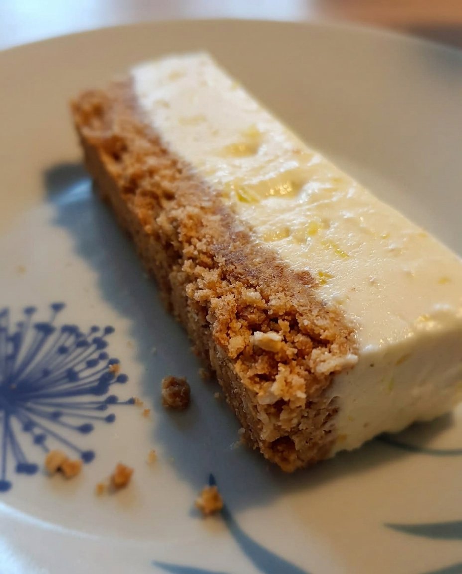 A springform pan wrapped in foil sitting in a roasting pan filled with water inside an oven