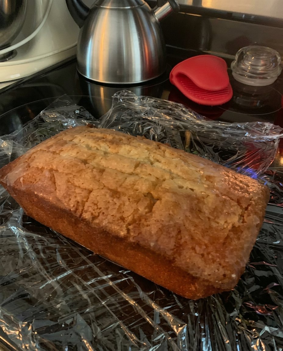 Lemon Drizzle Cake 13 Close up of hands using a vintage grater to zest a bright yellow lemon over a mixing bowl