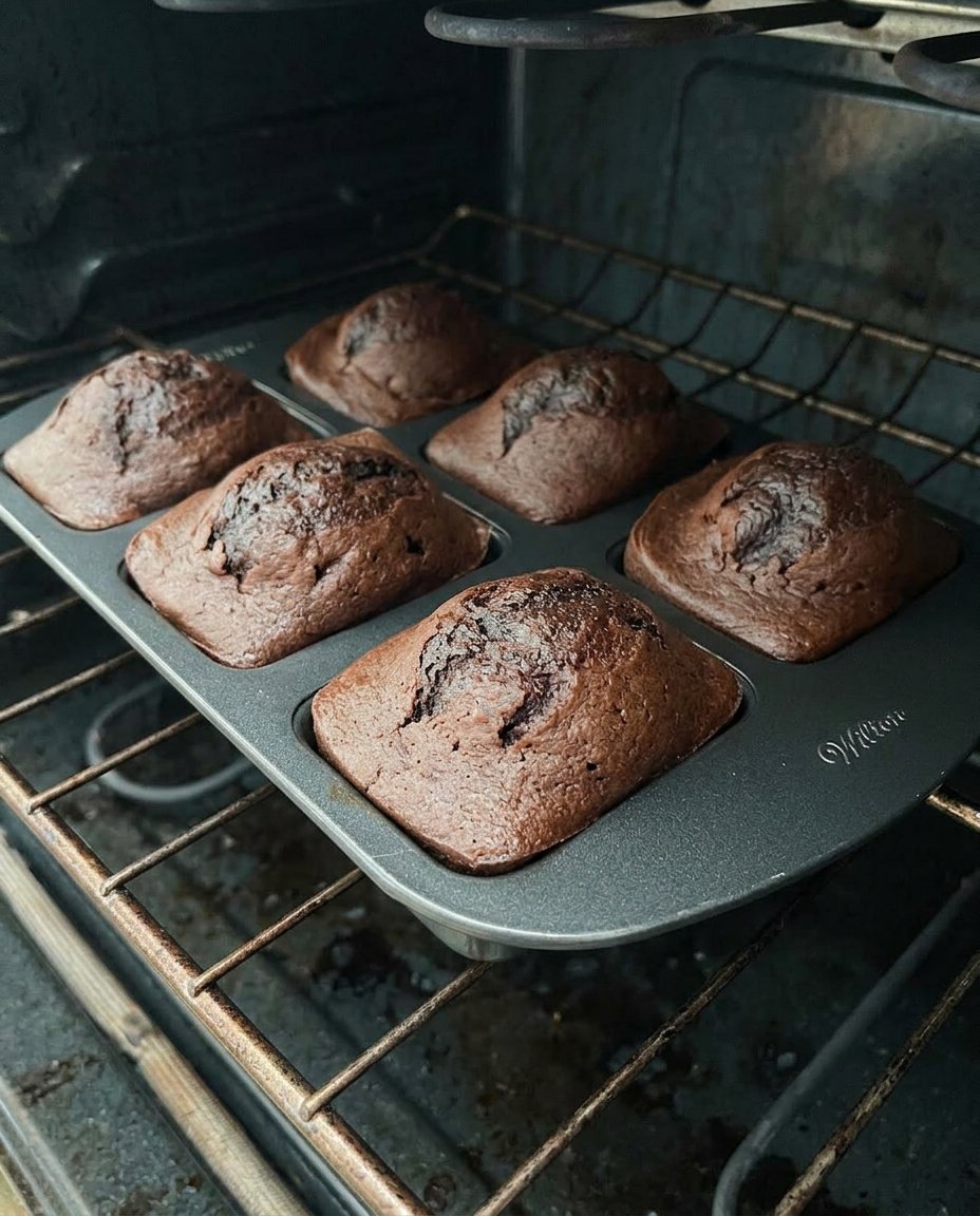 Ingredients for chocolate strawberry cake including a box of cake mix and a bowl of strawberries