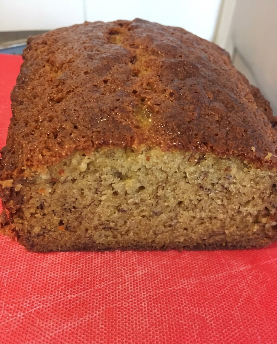 Banana Coffee Cake 14 A thick slice of banana coffee cake served on a plate with a cup of coffee