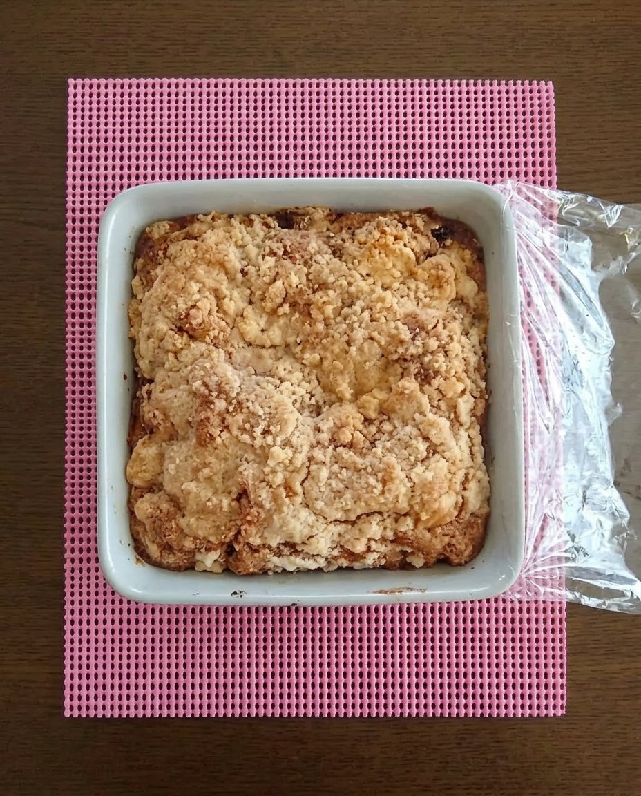 Strawberry Rhubarb Cake 10 A golden brown strawberry rhubarb cake sitting in a vintage 9x13 glass baking dish on a wooden table.