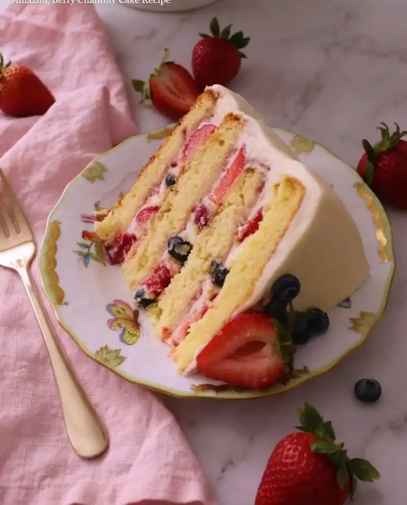Home - Cake Half - Small Batch Baking & Cupcakes 7 A four-layer Chantilly Bliss cake with fresh berries and white cream frosting on an antique table.