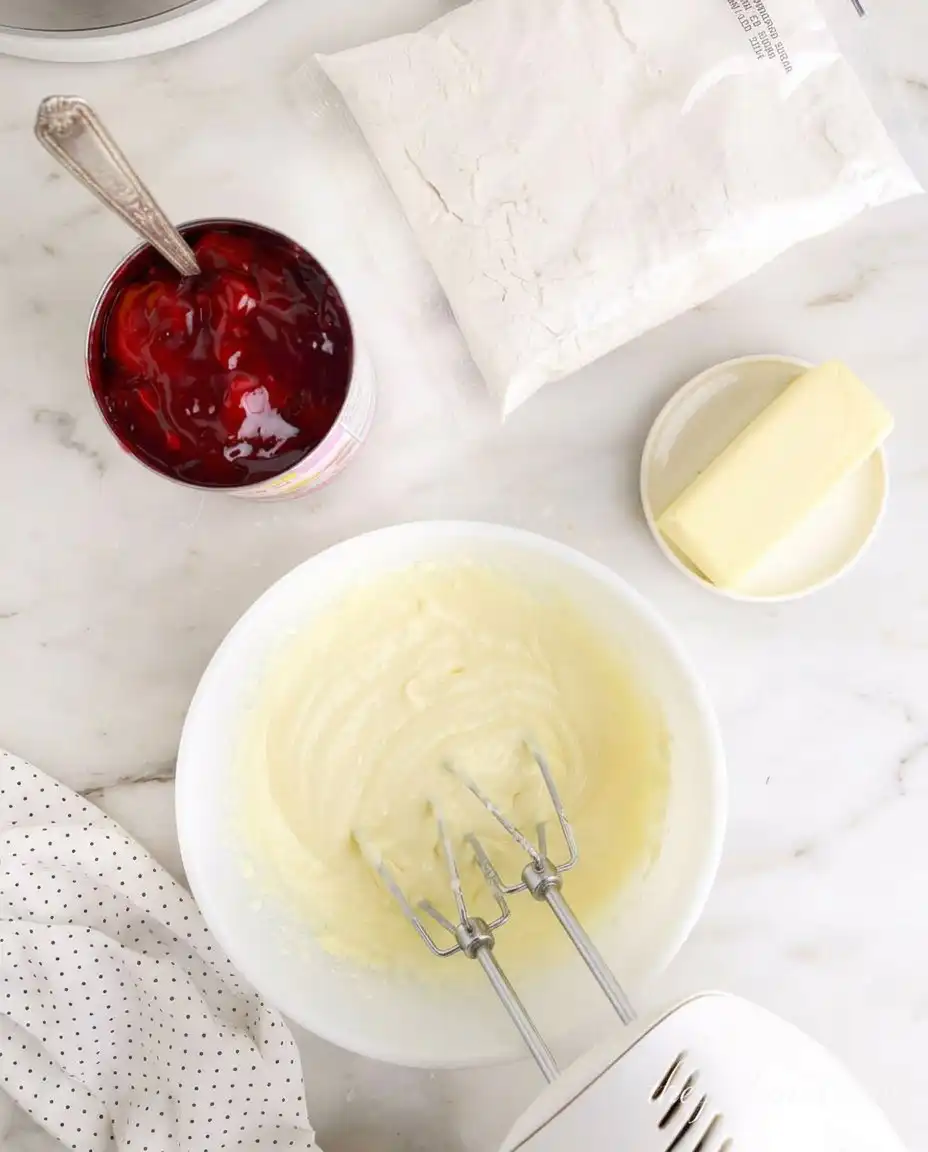 Cubes of cream cheese layered on top of yellow cake mix