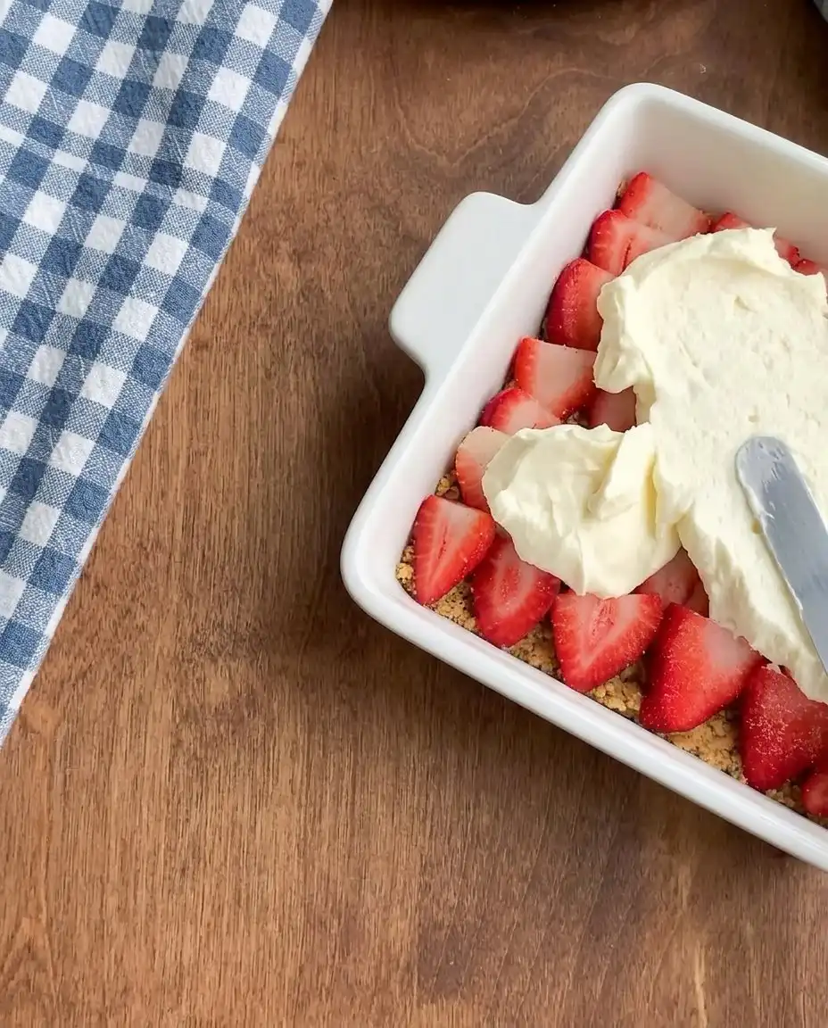 Close up of folding whipped cream into cream cheese for No-Bake Strawberry Dream