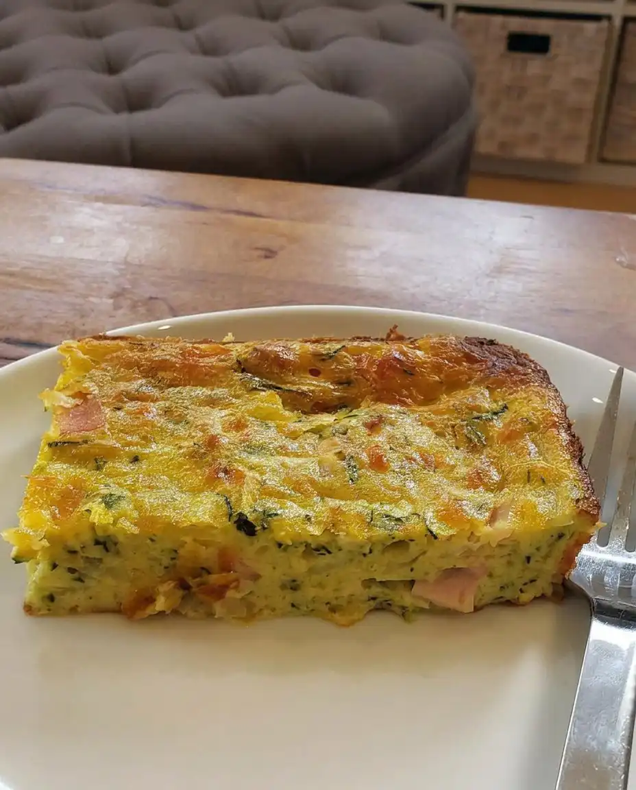 Zucchini pie served with a side salad and a glass of wine.