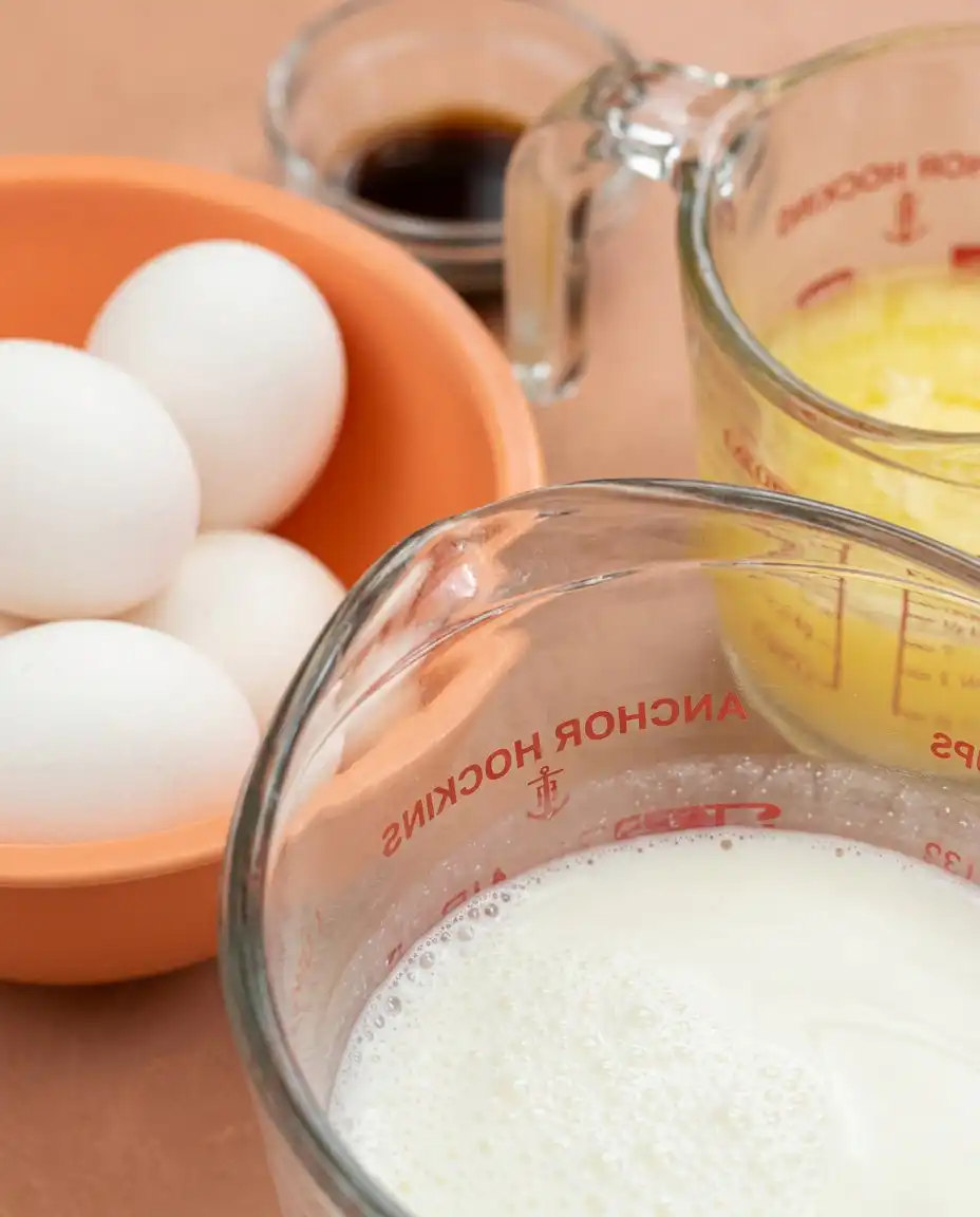 Bowls of cornmeal, flour, fresh peaches, and buttermilk for the Peach Cobbler Layer Cake.