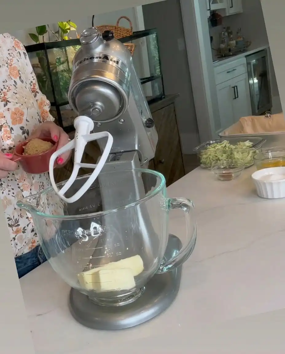 Fresh zucchini, butter, flour, and cinnamon on a kitchen counter