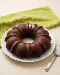A thick slice of Keto Chocolate Zucchini Cake sitting on a vintage floral china plate.