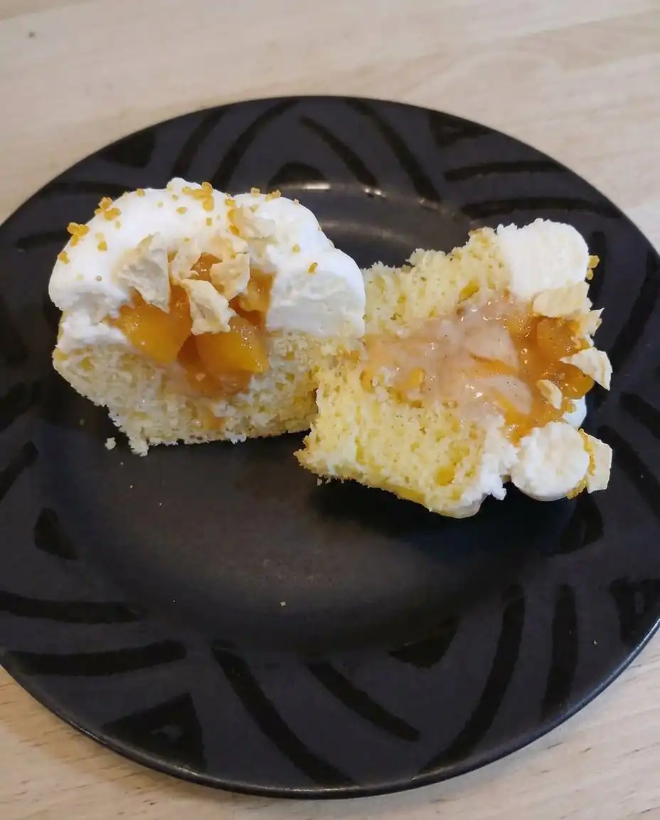 Creamy cheesecake batter being swirled with golden honey in a vintage glass bowl.