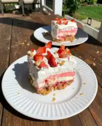 A beautiful No-Bake Strawberry Dream dessert topped with fresh sliced strawberries