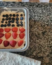 Overhead view of an Easy American Flag Cake No-Bake Cheesecake with cherry and blueberry filling stripes