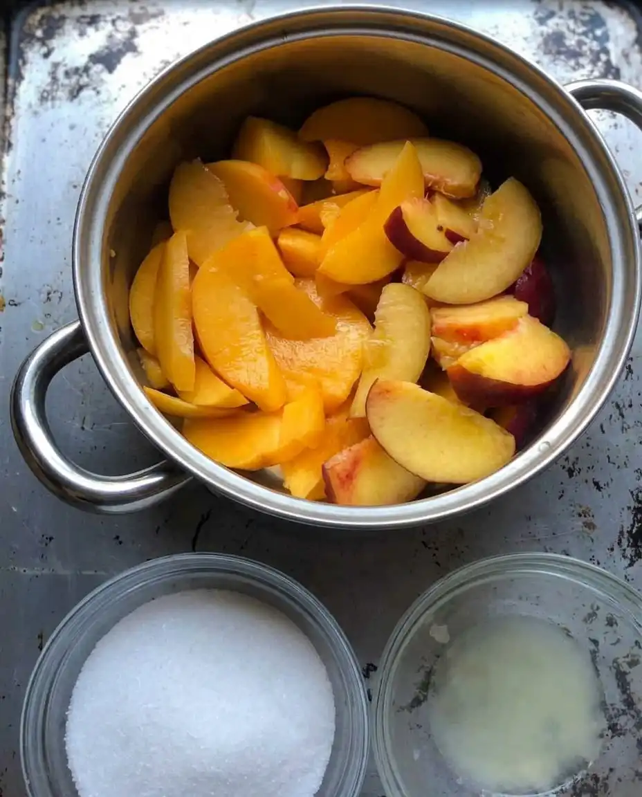 Peach cobbler bubbling in the oven with a cinnamon dusting