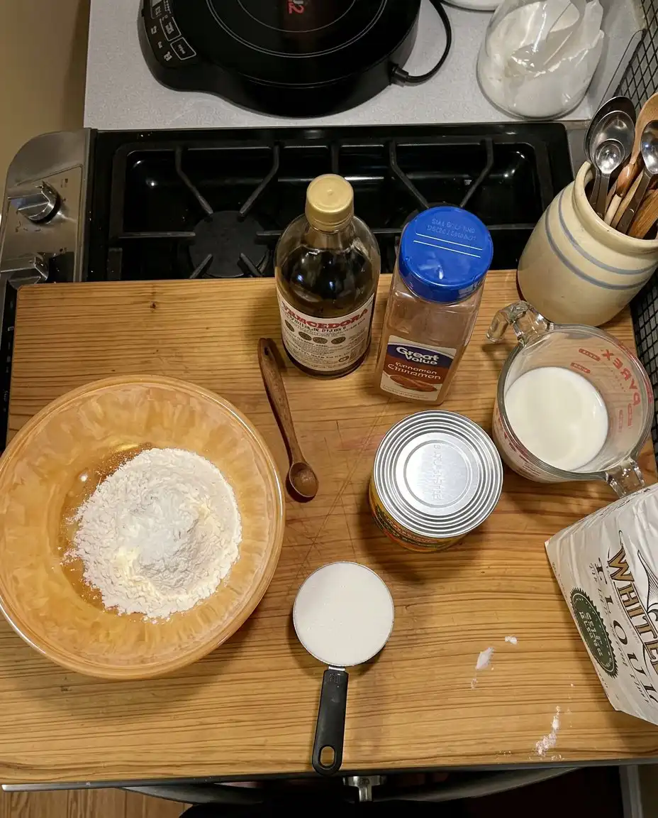 Ingredients for peach cobbler including flour sugar and canned peaches