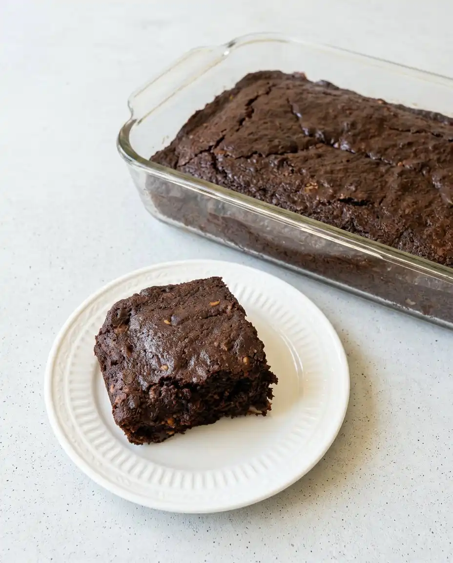 The finished Old-Fashioned Chocolate Zucchini Cake in a 9x13 pan with a dusting of sugar.