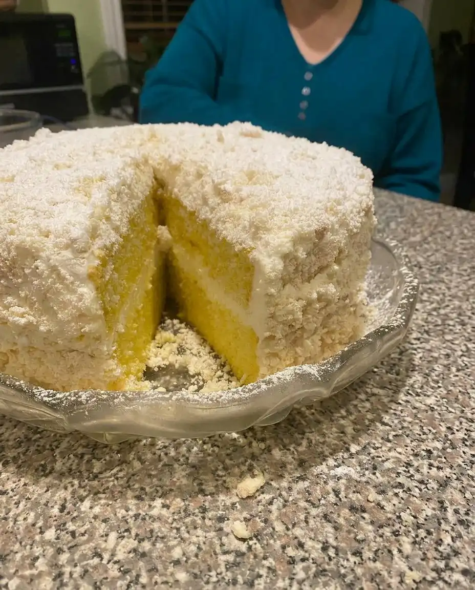 A plated slice of Italian Lemon Cream Cake garnished with mint
