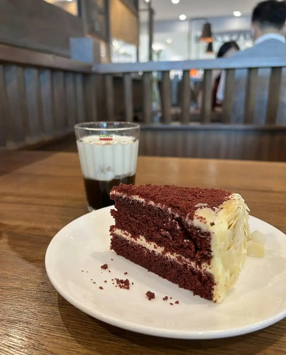 Three round red cake layers cooling on a wire rack