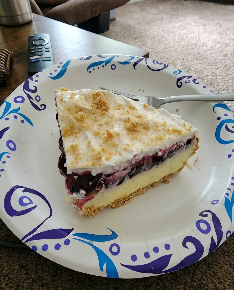 A square of lemon blueberry dessert served on a vintage floral china plate.