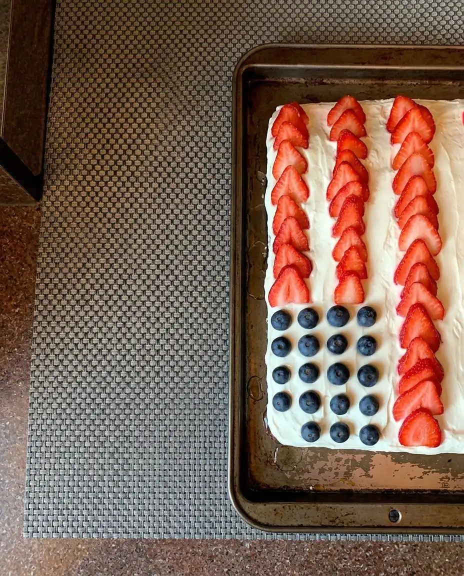 Slicing a festive berry flag cake onto vintage china plates