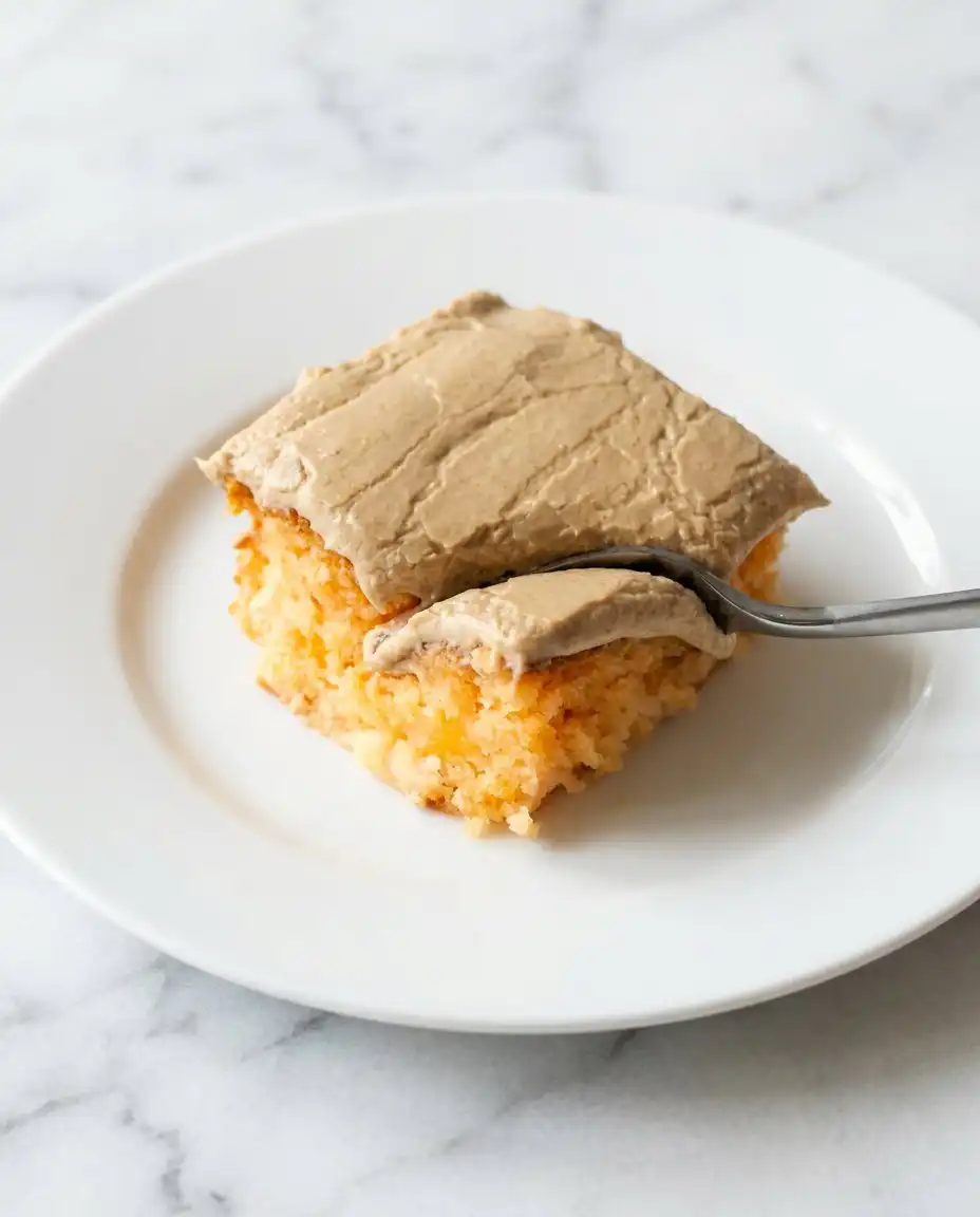 Peach Cake with Brown Sugar Frosting 16 A square slice of Peach Cake with Brown Sugar Frosting on a floral patterned vintage plate.