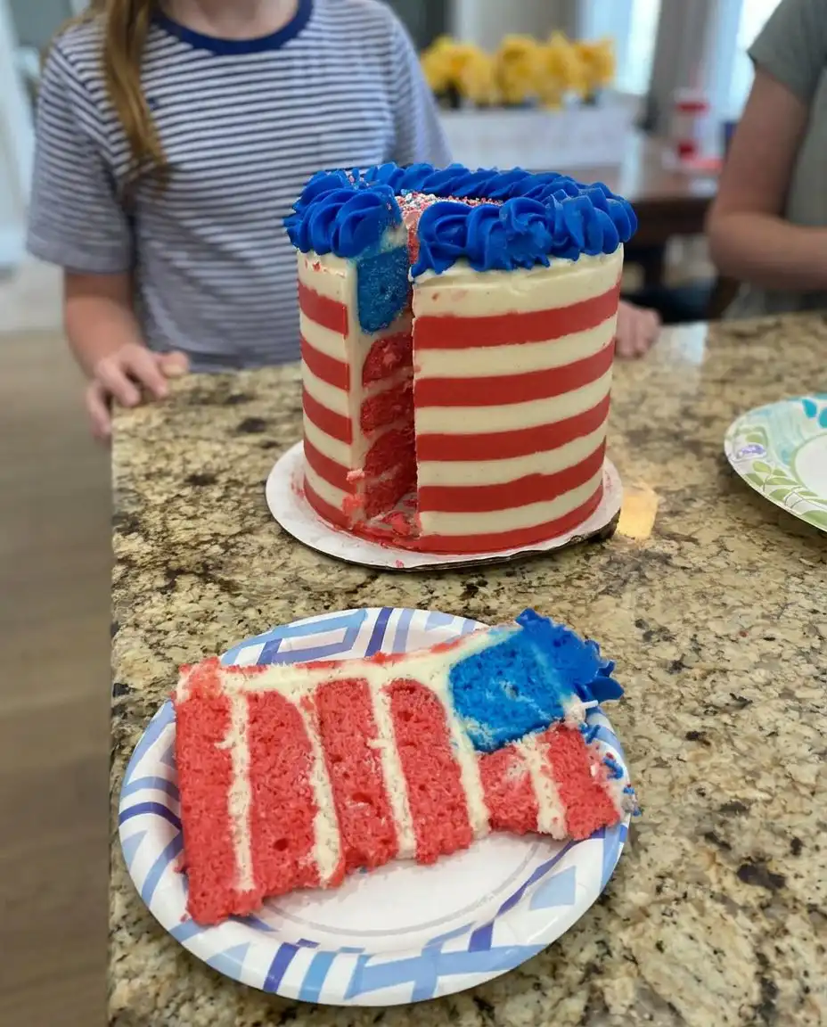 A slice of American Flag Cake showing four layers of vanilla cake