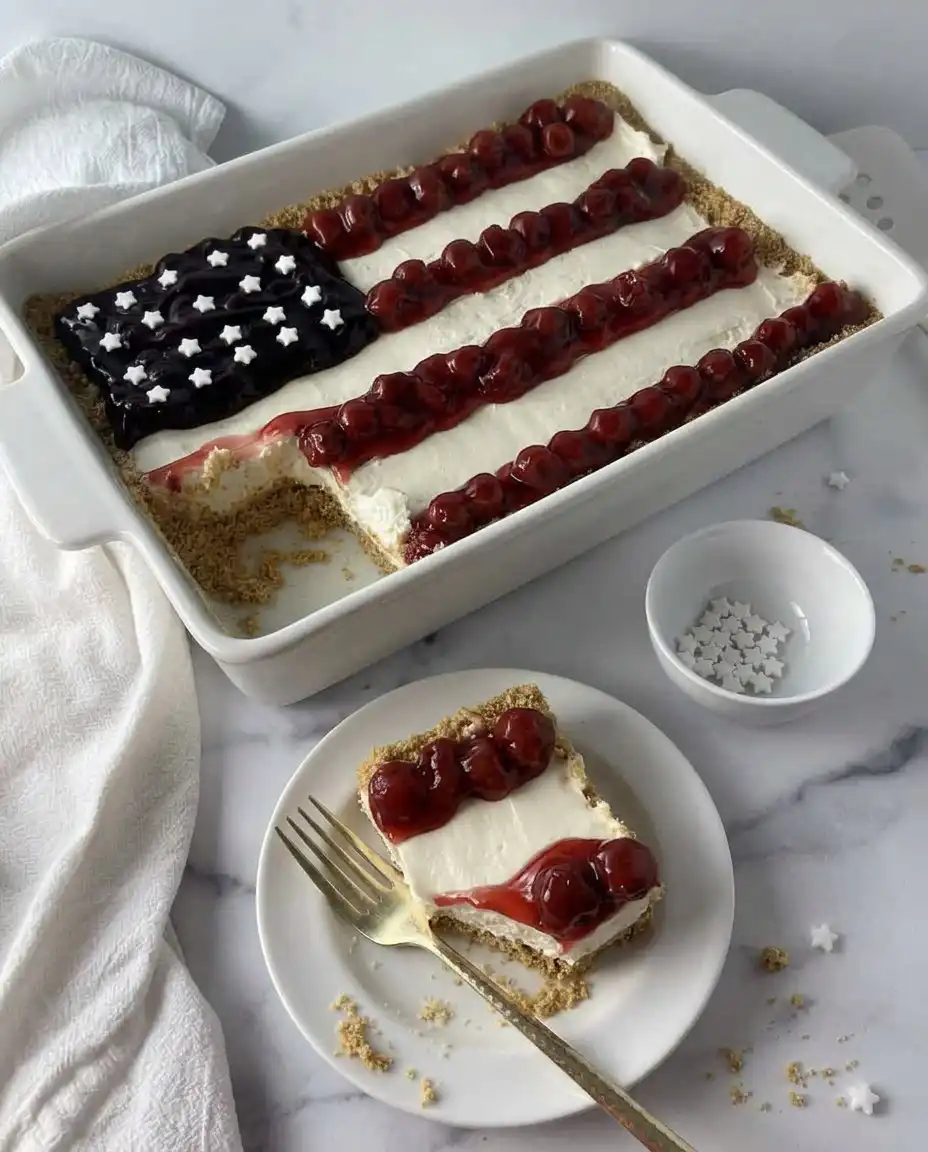 A clean slice of no-bake American flag cheesecake showing the thick graham cracker crust.