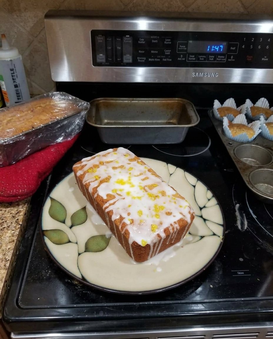 Sliced lemon zucchini bread on a white porcelain plate with a lemon slice