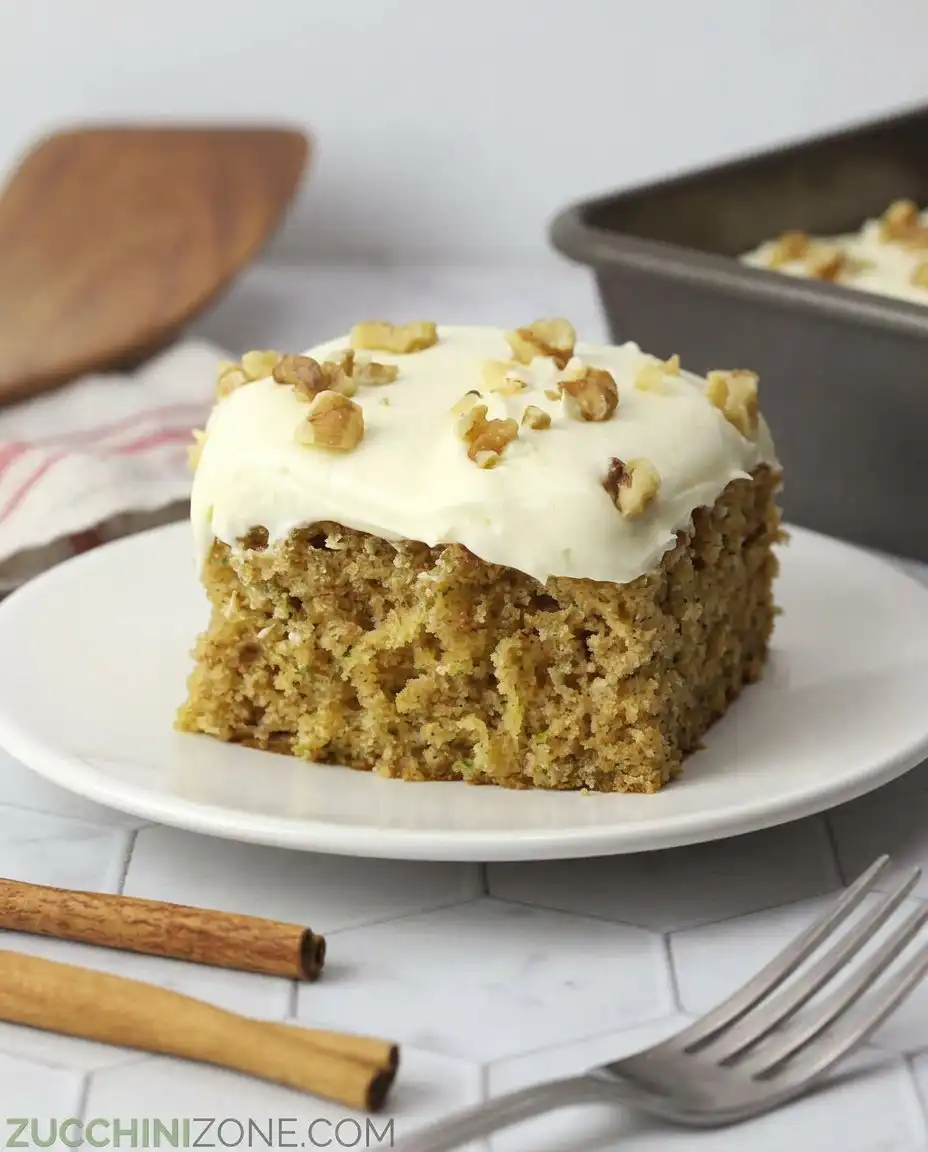 Two slices of zucchini spice cake next to a vintage coffee cup