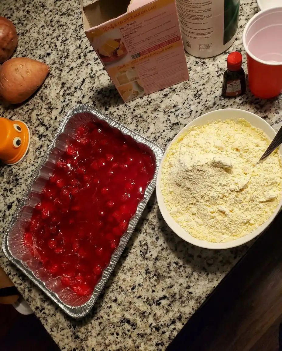 A saucepan showing the thickened glossy strawberry glaze for Strawberry Heaven.