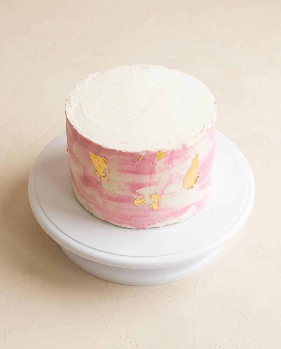 A clean slice of a Two-Layer Watercolor Buttercream Cake showing internal layers.