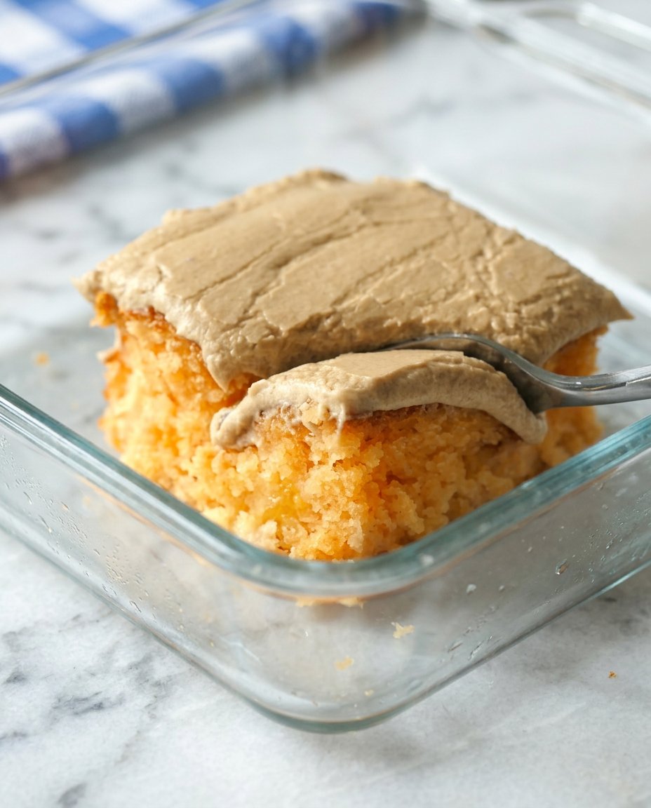 Peach Cake with Brown Sugar Frosting 12 A golden Peach Cake with Brown Sugar Frosting served on a white lace tablecloth with a vintage fork.