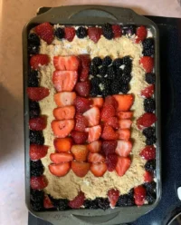 A beautiful slice of Red White and Blue Mixed Berry Yum Yum on a vintage floral plate