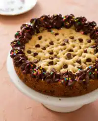 A freshly baked Brown Butter Chocolate Chip Cookie Cake cooling in a classic round cake pan.