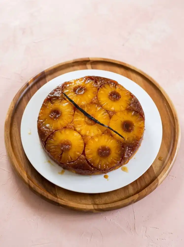 A golden Pineapple Upside-Down Cake showing the caramelized pineapple rings on a platter.