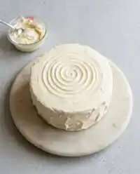 A classic red velvet layer cake cooling on a wire rack in a heritage kitchen