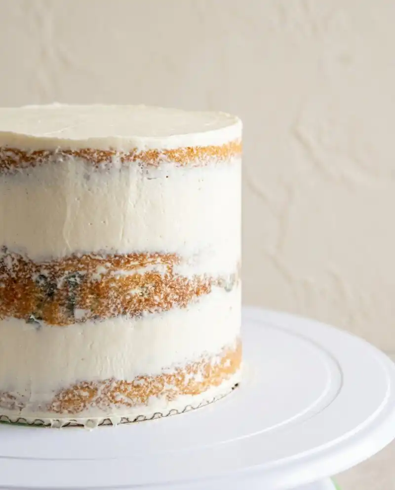 Home - Cake Half - Small Batch Baking & Cupcakes 8 A beautiful classic vanilla naked cake decorated with fresh raspberries on a white vintage cake stand.
