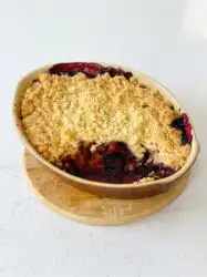 A freshly baked Blackberry Apple Dump Cake with a golden brown buttery crust in a baking pan