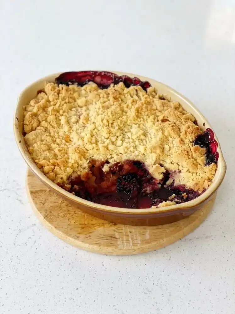 A freshly baked Blackberry Apple Dump Cake with a golden brown buttery crust in a baking pan