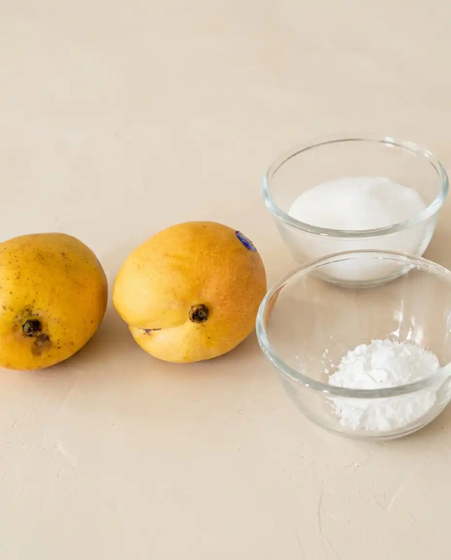 Mango Ombre Cake 14 Fresh ingredients for a Mango Ombre Cake design laid out in small glass bowls on a kitchen counter.