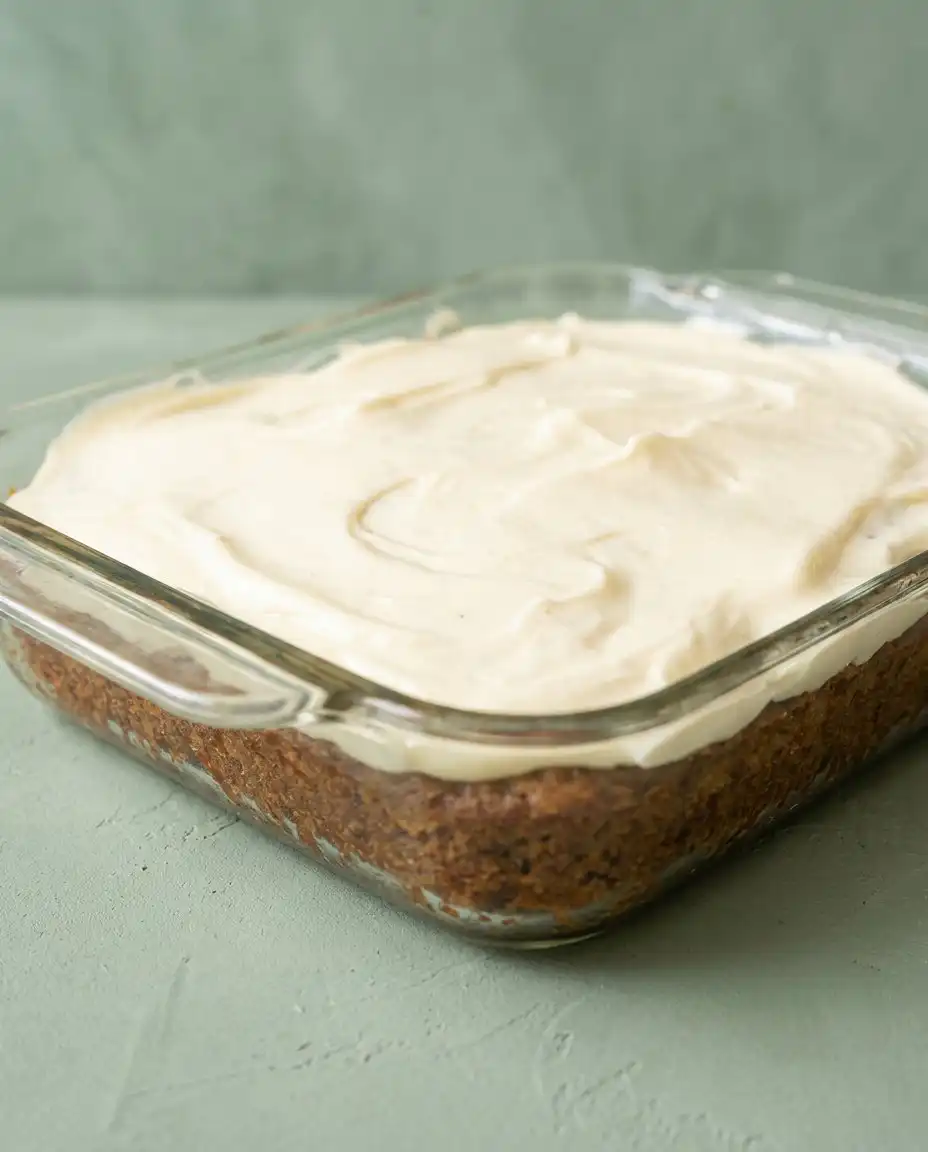 Serving a square of Pineapple Sheet Cake with Cream Cheese Frosting to guests.