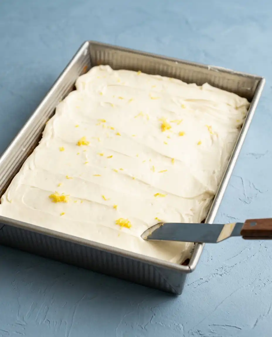 Slices of Zucchini Cake with lemon cream cheese frosting being served with tea