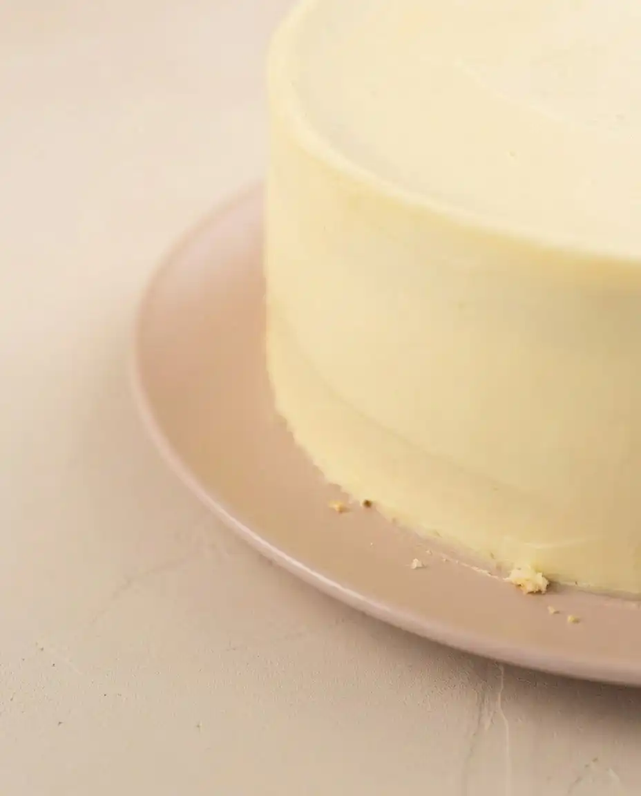 A delicious slice of Mango Birthday Layer Cake served on elegant vintage floral china