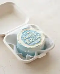 A beautiful vintage Chocolate Lunch Box Cake resting on a rustic wooden countertop