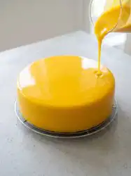A stunning homemade Mango Passion Fruit Mousse Cake decorated with fresh whipped cream and diced mangoes.